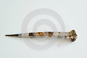 An ancient iron nail on white background