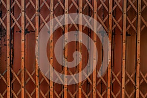 Ancient iron orange doors are very rusty for background, Steel folding gates, thailand