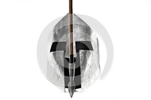 Ancient iron spartan helmet and arrow isolated on white.