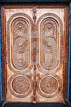 ancient Islamic pattern Uzbek traditional ornament on wooden carved door in Museum of Political Repression in Uzbekistan photo