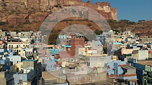 Ancient Jaisalmer Fort, India city with white and blue houses.