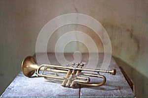 an ancient Jazz trumpet on an ancient wooden table