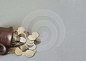 Ancient jug with coins. Old coins in a pot.