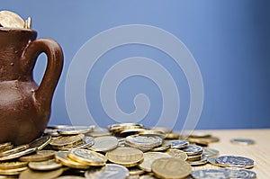 Ancient jug with coins. Old coins in a pot.