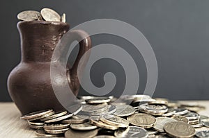 Ancient jug with coins. Old coins in a pot.