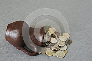 Ancient jug with coins. Old coins in a pot.