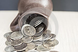 Ancient jug with coins. Old coins in a pot.