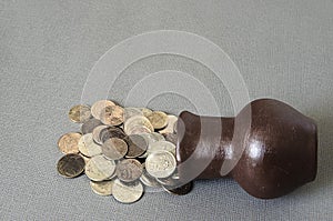 Ancient jug with coins. Old coins in a pot.