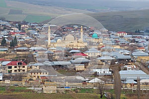 Ancient Juma mosque in the city landscape on a cloudy January day. Shemakha. Azerbaijan Republic