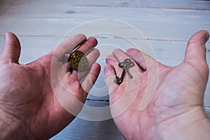 Ancient key and bronze heart in a hand