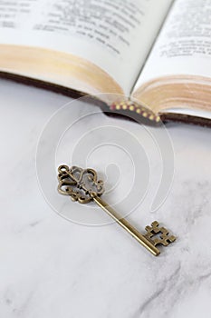 Ancient key with open holy bible book