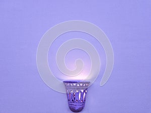 Ancient lamp on the purple wall
