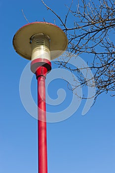 Ancient lamppost at parking of gasstation on highw