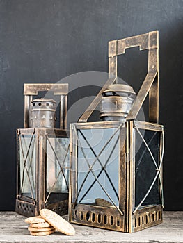 Ancient lantern. Old vintage metal railway lamp on black background. Artistic still life