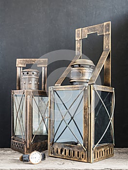 Ancient lantern. Old vintage metal railway lamp on black background. Artistic still life