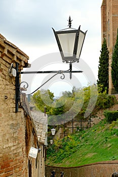 Ancient lantern for street lighting. A street lamp in the city of Siena in Tuscany.