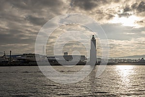 The ancient lighthouse of the port of Livorno, Italy, against a dramatic sky