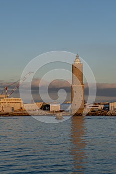 The ancient lighthouse of the port of Livorno, Italy, in the sunset light