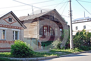 The ancient lordly inhabited wooden house on Karl Marx Street in the city of Syzran. Summer city landscape. Samara region. photo