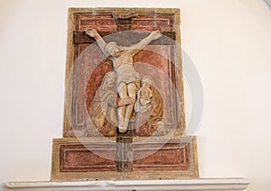 Ancient low relief in stone of the Crucifixion inside theChurch of San Nicola from Myra, Locorotondo, Italy