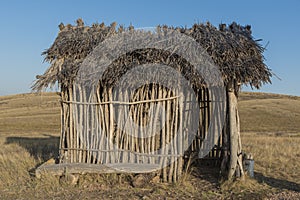 Ancient man. straw roof hut, bungalow.