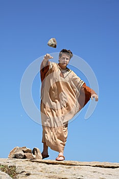 Ancient man throwing stone