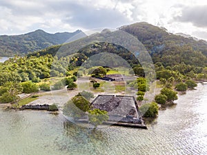 Ancient Marae Taputapuatea temple complex, lagoon shore with mountains background. Raiatea island. French Polynesia, Oceania.