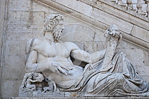 Ancient marble statue of the god of the river Tiber, protecting Romulus and Remus with his right arm, from the Capitoline Hill