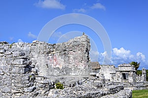 Ancient Mayan building ruins against blue sky in Tulum, Yucatan