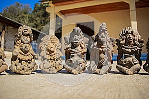 Ancient mayan figures with different styles sitting