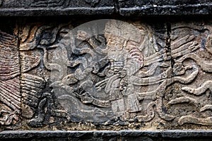 Ancient Mayan mural depicting a warrior holding a human head