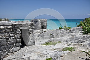 Ancient Mayan ruin perched on a rocky shoreline