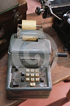 Ancient mechanical calculator manual with worn keys