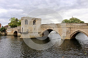 Ancient Medieval bridge over the river Ouse at St Ives with the Bridge chapel clearly visible.
