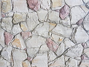 Ancient medieval stone masonry. Texture of a fragment of a wall of an old structure. A background for design and creative work.