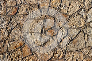 Ancient medieval stone masonry. Texture of a fragment of a wall of an old structure. A background for design and creative work. De