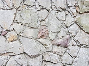 Ancient medieval stone masonry. Texture of a fragment of a wall of an old structure. A background for design and creative work. De