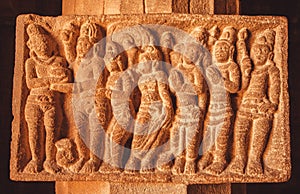 Ancient men and women figures on stone relief of 7th century Hindu templ. Carved architecture of India. photo