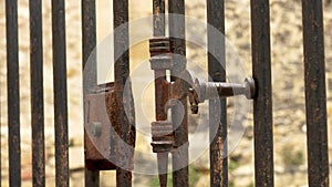 Ancient metal rusty wrought latch. Handle deadbolt of the door of the lattice gate
