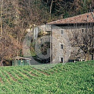 Ancient mill with a waterfall by side