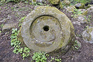 ancient millstone on ground