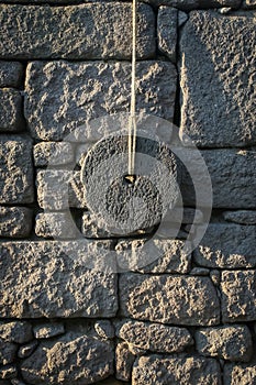 Ancient Millstone On The Wall