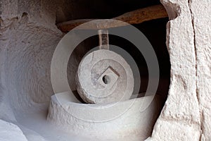 Ancient millstone in Zelve Open Air Museum in Cappadocia, Turkey photo