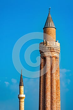 Ancient minarets with loudspeakers against the sky