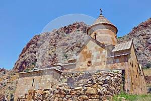 Ancient Monastery Noravank built of natural stone tuff. Landscaped view of the stone mountains.