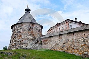 Ancient monastery tower and fragment of wall