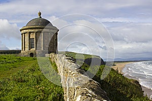 The ancient Mussenden Temple Monument on the clifftop edge overlooking Downhill Beach in County Londonderry Northern Ireland photo