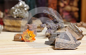 Ancient Native American Pottery Pieces With Crystals and Flowers on Meditation Table