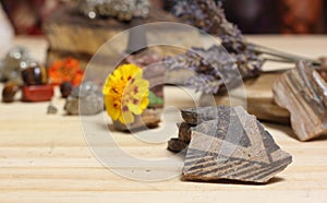 Ancient Native American Pottery Pieces With Crystals and Flowers on Meditation Table