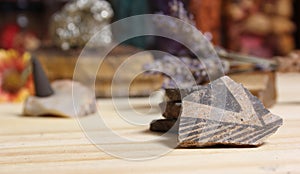 Ancient Native American Pottery Pieces With Crystals and Flowers on Meditation Table